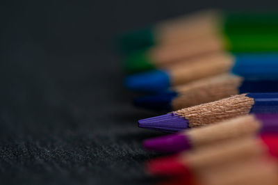 Close-up of colored pencils on wood