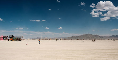 People on beach against sky