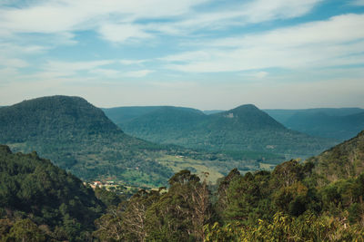 Rural landscape of a valley with hills covered by forests in the foreground near canela, brazil.