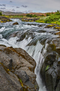Scenic view of stream flowing through rocks