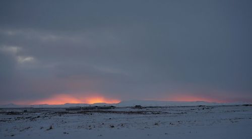 Scenic view of landscape against sky at sunset