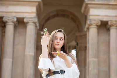 Portrait of young woman standing outdoors