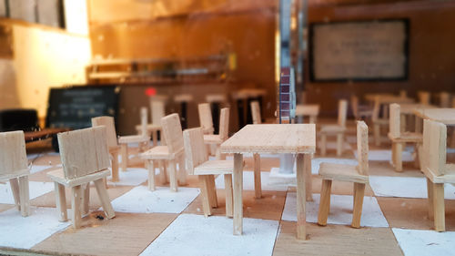 Close-up of chairs on table