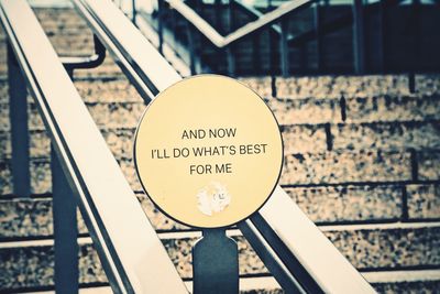 Close-up of sign on railing