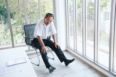 Portrait of a smiling young man sitting on chair