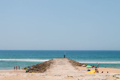 Scenic view of beach against clear sky