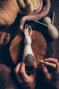 High angle view of man holding toy on table