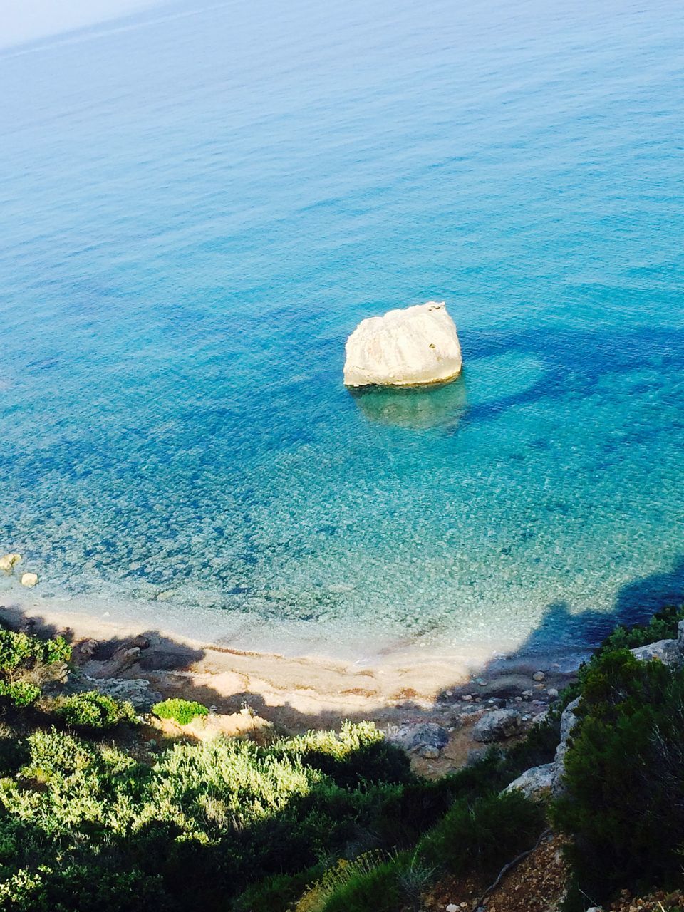 tranquil scene, tranquility, scenics, sea, water, beauty in nature, blue, nature, landscape, idyllic, high angle view, non-urban scene, grass, horizon over water, sky, coastline, rock - object, rock formation, remote, rock