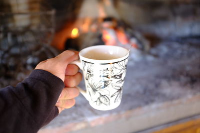 Close-up of hand holding tea cup