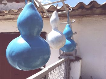 Close-up of clothes hanging on railing against wall