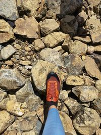 Low section of person standing on rock