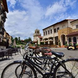 Bicycles parked on road against buildings in town