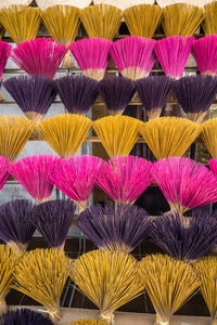 Bouquets of colorful incense sticks made by hand. the incense sticks dry in the sun.