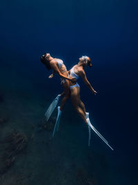 Rear view of woman swimming in sea