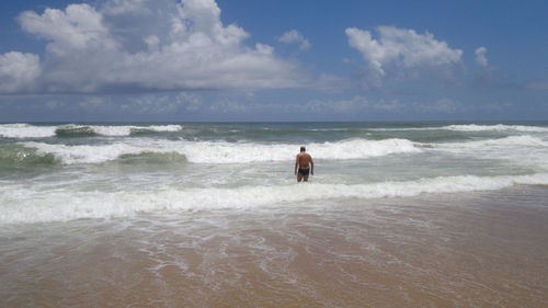 Man on beach against sky