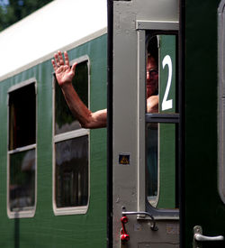 Portrait of senior man waving in train