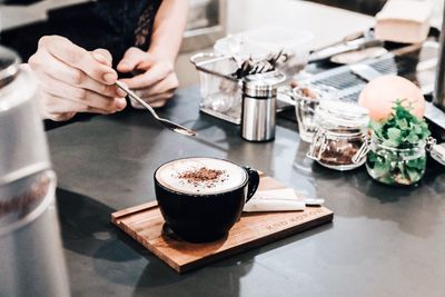 Midsection of coffee cup on table