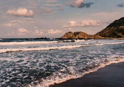 Scenic view of beach against sky during sunset