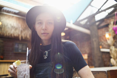 Portrait of young woman standing outdoors