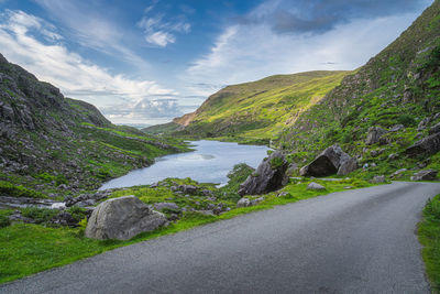 Road by mountain against sky