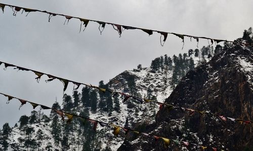 Low angle view of snow on mountain against sky