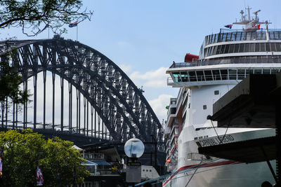 Low angle view of bridge in city against sky