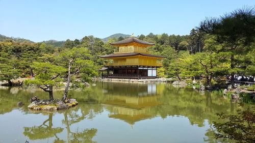 Built structure by lake against sky