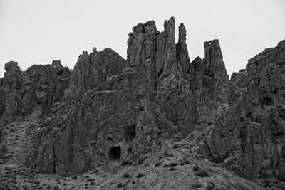 Low angle view of rocks on mountain against sky