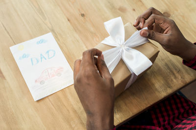 Cropped hands of woman holding gift box