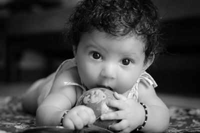 Portrait of cute baby girl with toy
