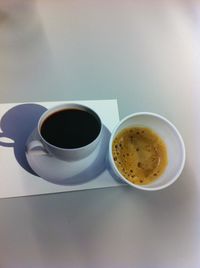 Coffee cup with coffee cup on table