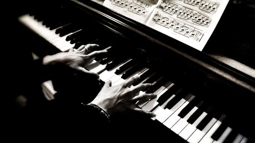 Cropped image of hand holding piano