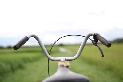 Close-up of bicycle leaning against blurred background