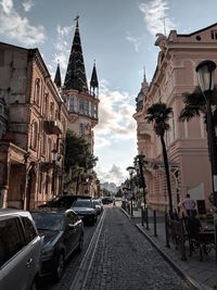 Street amidst buildings against sky in city