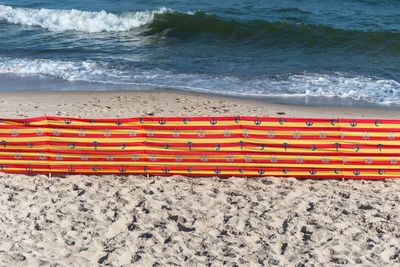 Beach screen on the polish beach on a sunny summer day in the background a rough sea.