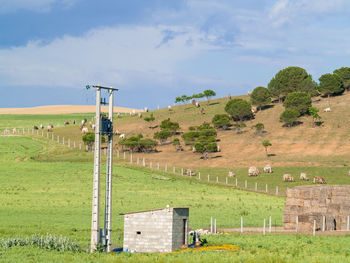 Built structure on field against sky