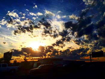 Silhouette city against sky during sunset