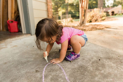 Girl drawing on street