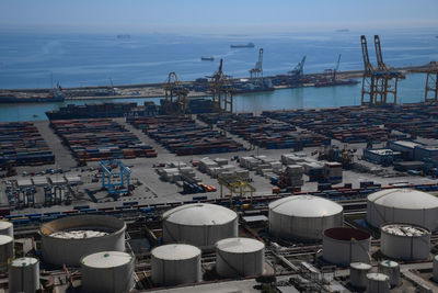 Cargo port of barcelona. high angle view of commercial dock against sky