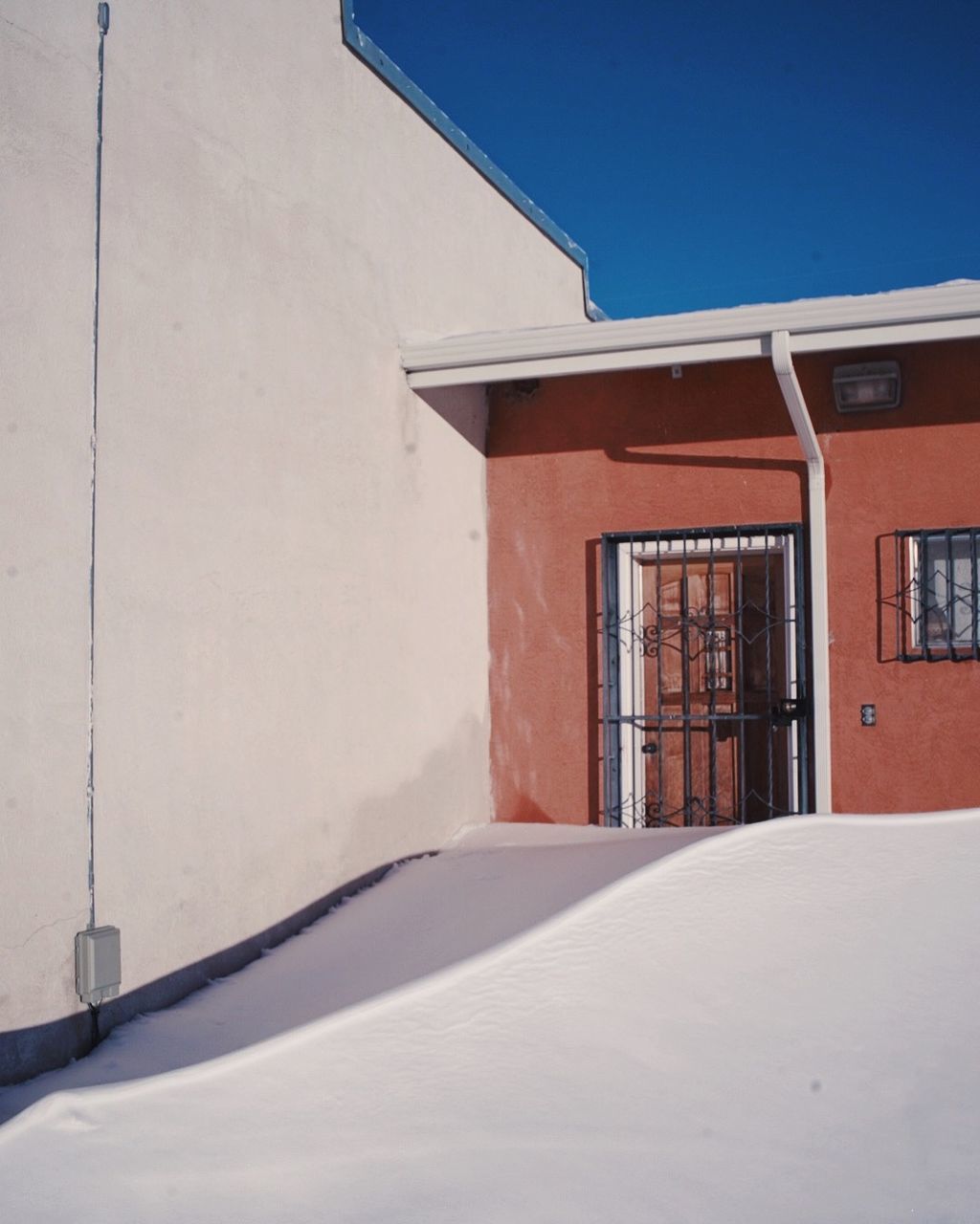 architecture, built structure, building exterior, building, no people, window, white color, day, mode of transportation, nature, house, snow, sunlight, transportation, car, motor vehicle, outdoors, winter, sky