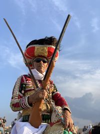 Low angle view of man standing against sky