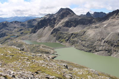 Scenic view of lake and mountains against sky