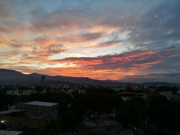 High angle view of townscape against orange sky