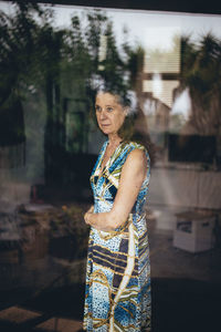 Young woman standing against blurred background