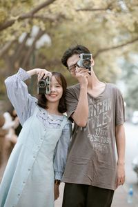 Full length of a young woman photographing