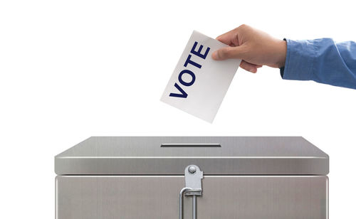 Low section of person holding box against white background