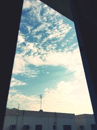 Low angle view of building against cloudy sky