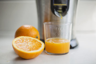 Close-up of orange juice in glass on table