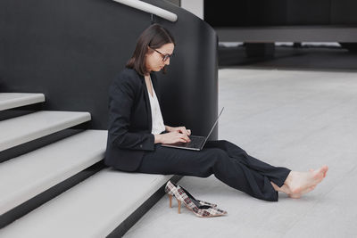 Low section of woman sitting on staircase