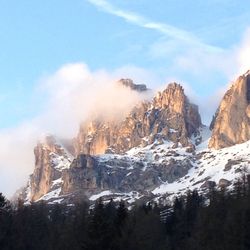 Scenic view of mountains against cloudy sky